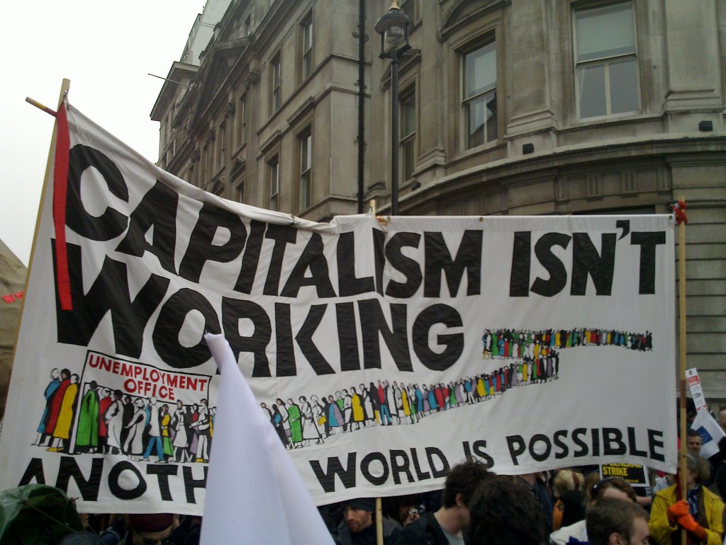 Sign that says "Capitalism isn't working"